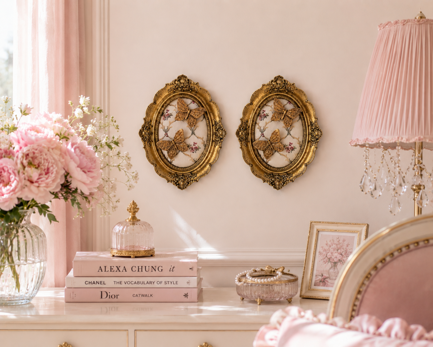 Pair of gold butterfly oval frames styled in a pink romantic bedroom
