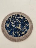 Two ornate navy and silver round table toppers displayed side by side