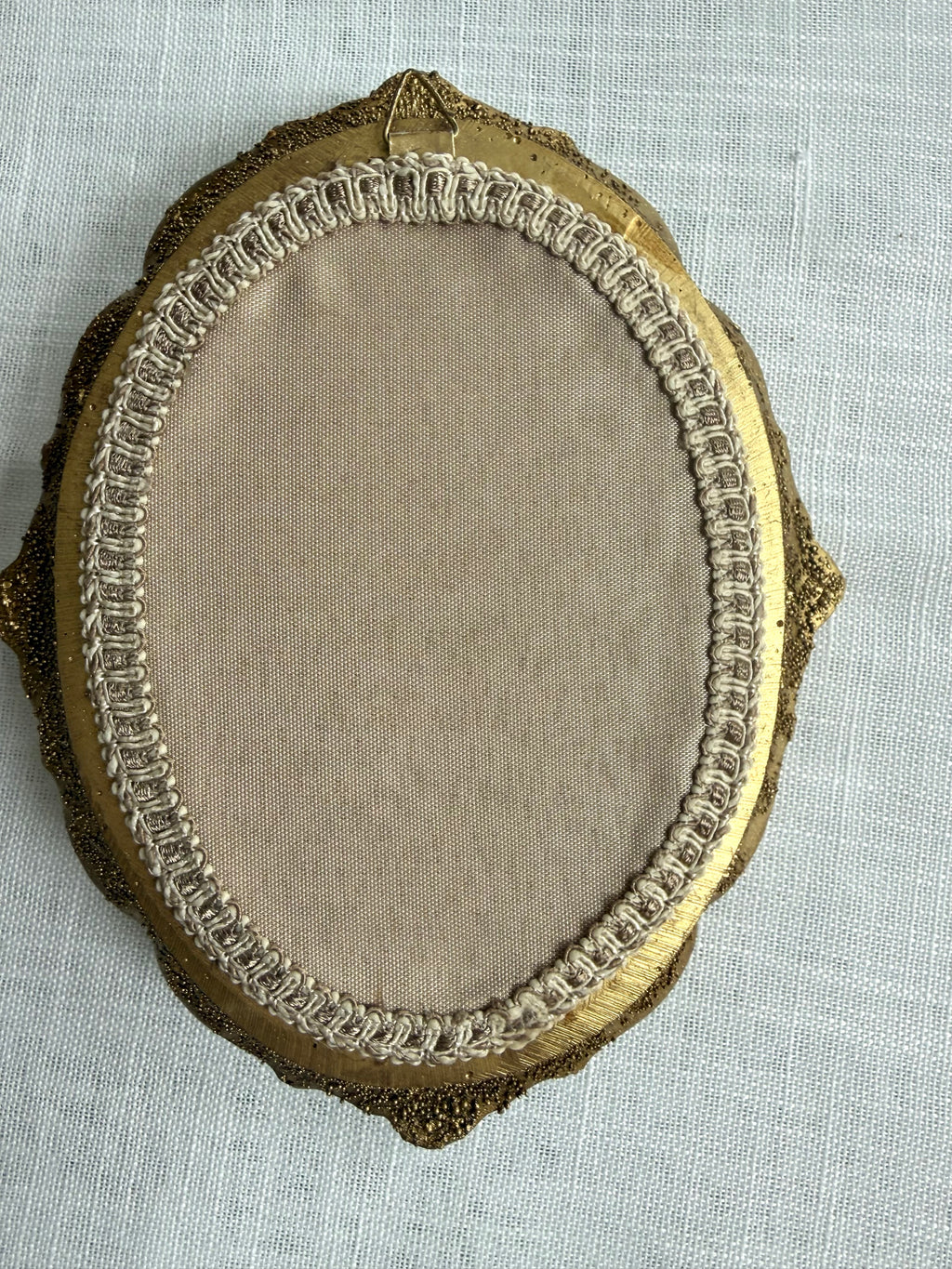 Back of oval frame showing hanging hardware