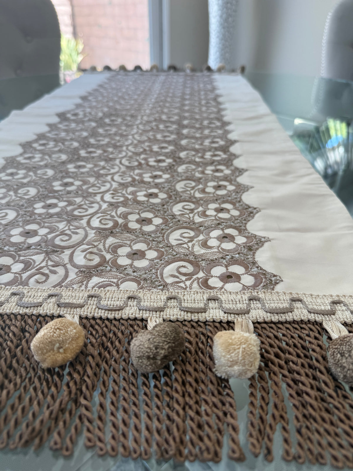 Floral lace table runner styled on a glass dining table
